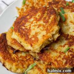 A close-up of a stack of golden, crispy potato pancakes.