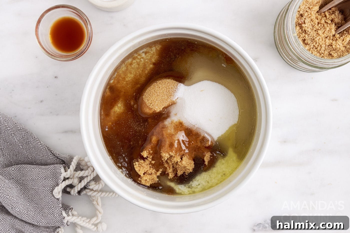 Corn syrup, brown sugar, and granulated sugar stirred into melted butter in a microwave-safe bowl.