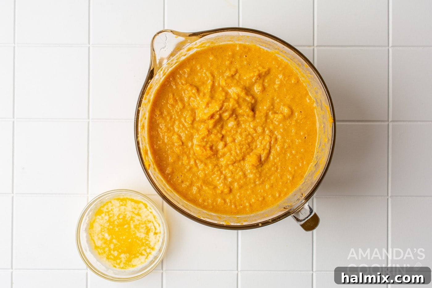 Mashed sweet potatoes being mixed with the creamy filling ingredients