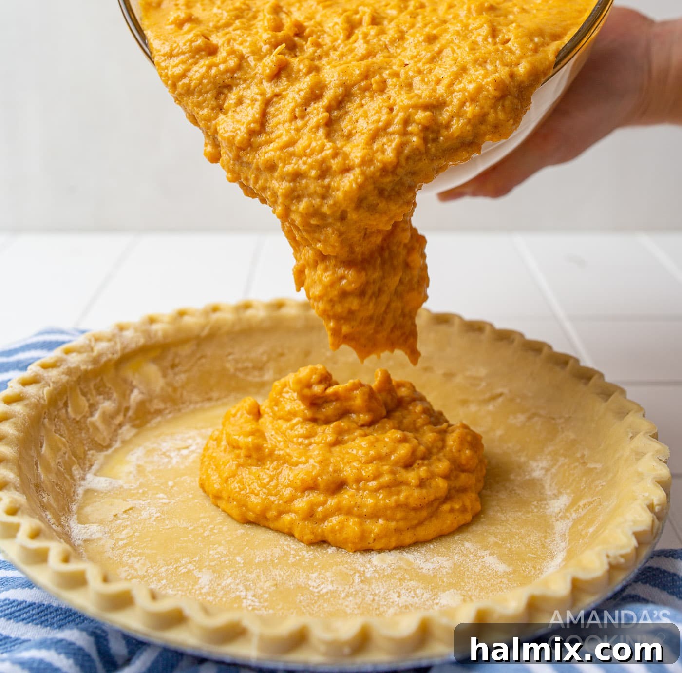 Pouring the sweet potato mixture into two pie crusts