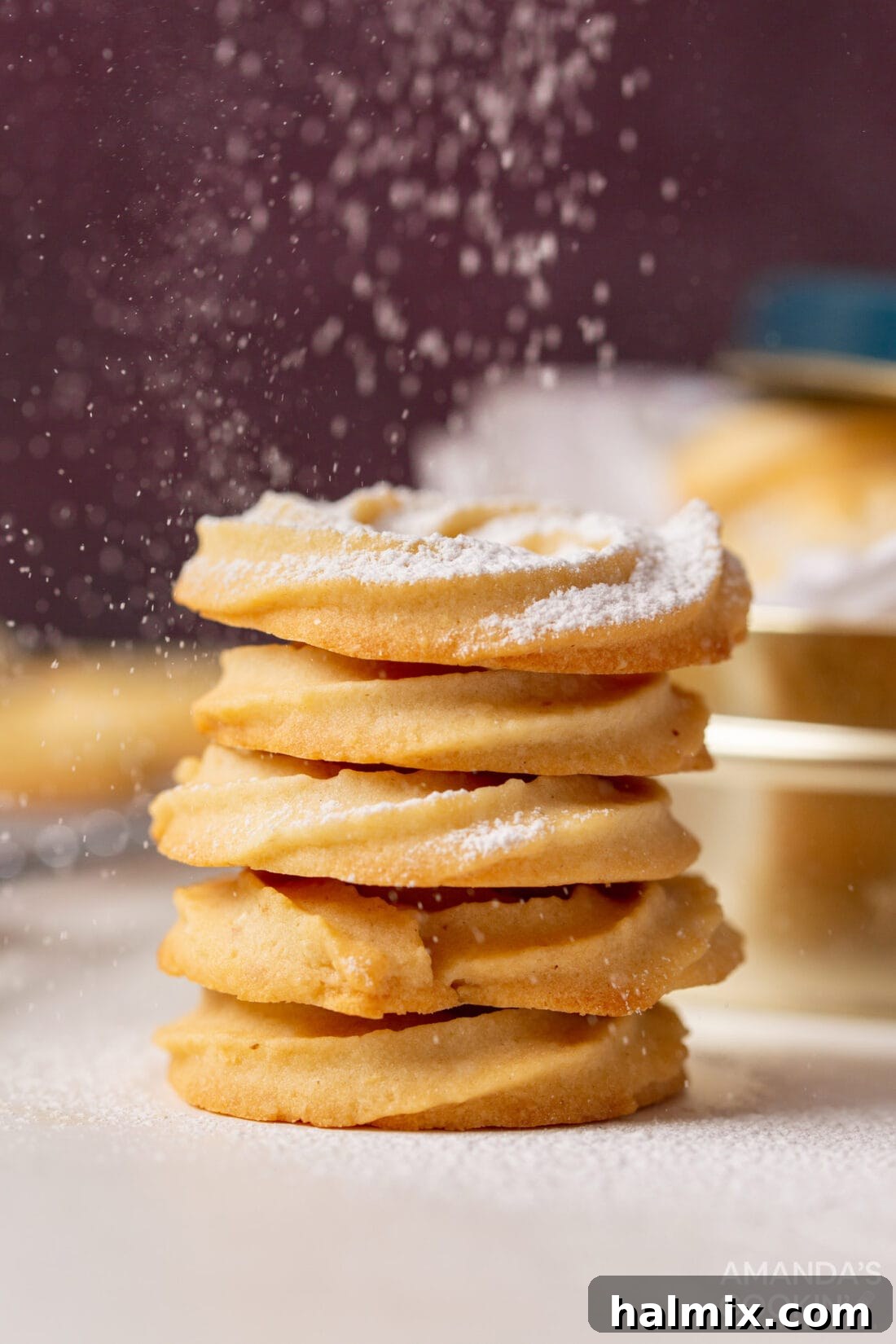 Buttery Danish Delights 3 Danish Butter Cookies being dusted with powdered sugar