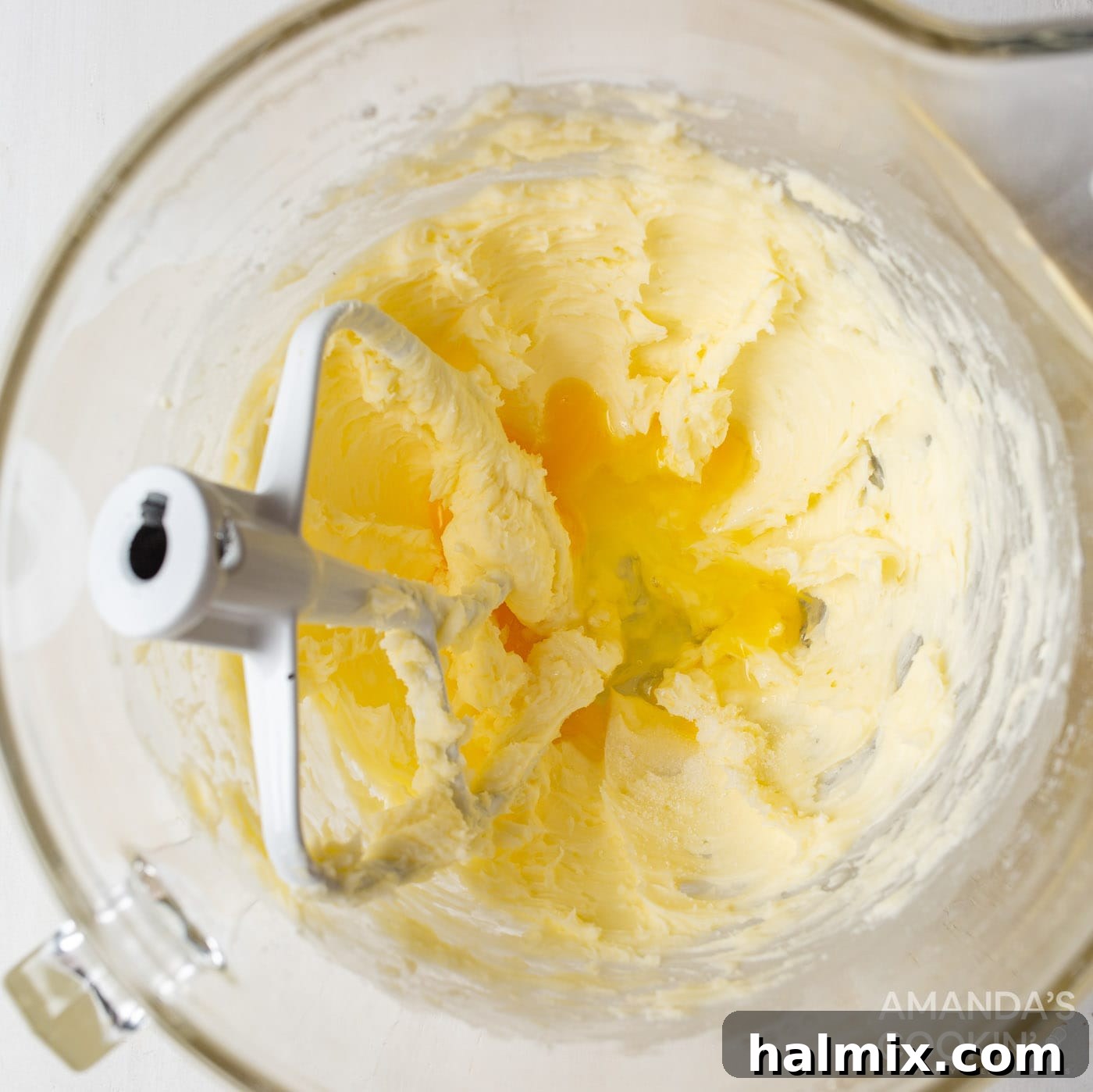 creamed butter and sugar mixture with egg and vanilla in a bowl with paddle attachment