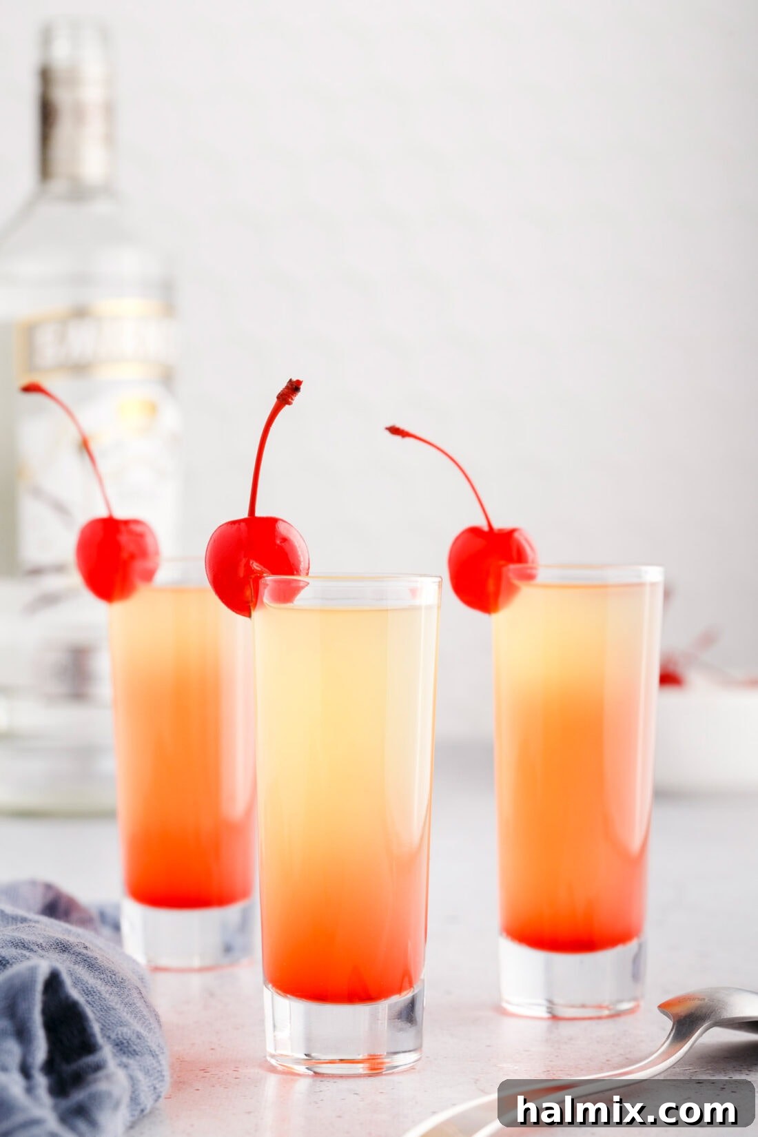 Three Pineapple Upside Down Cake Shots arranged beautifully, ready to be served.