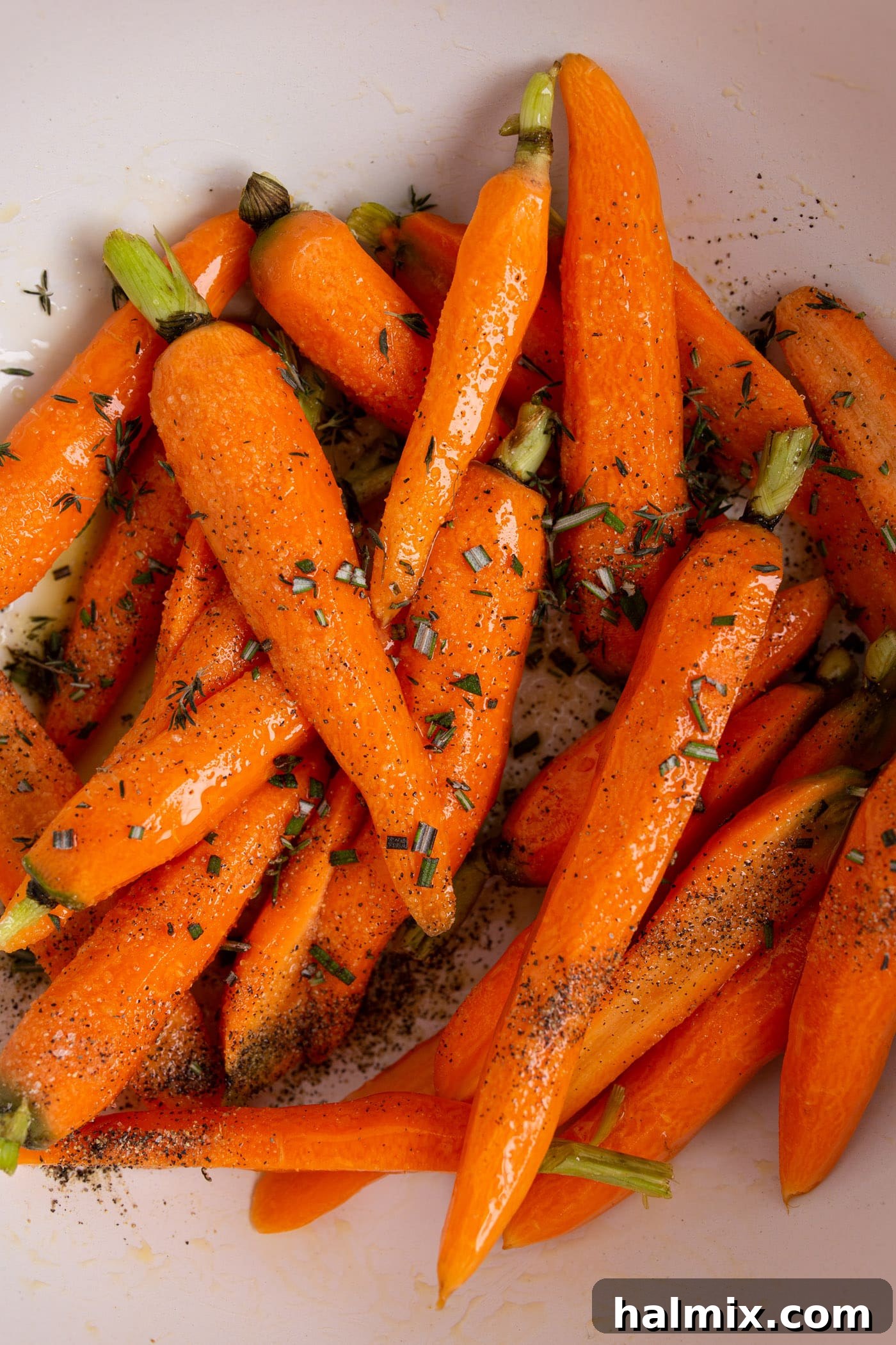 Caramelized Roasted Carrots 5 carrots in a bowl with seasonings