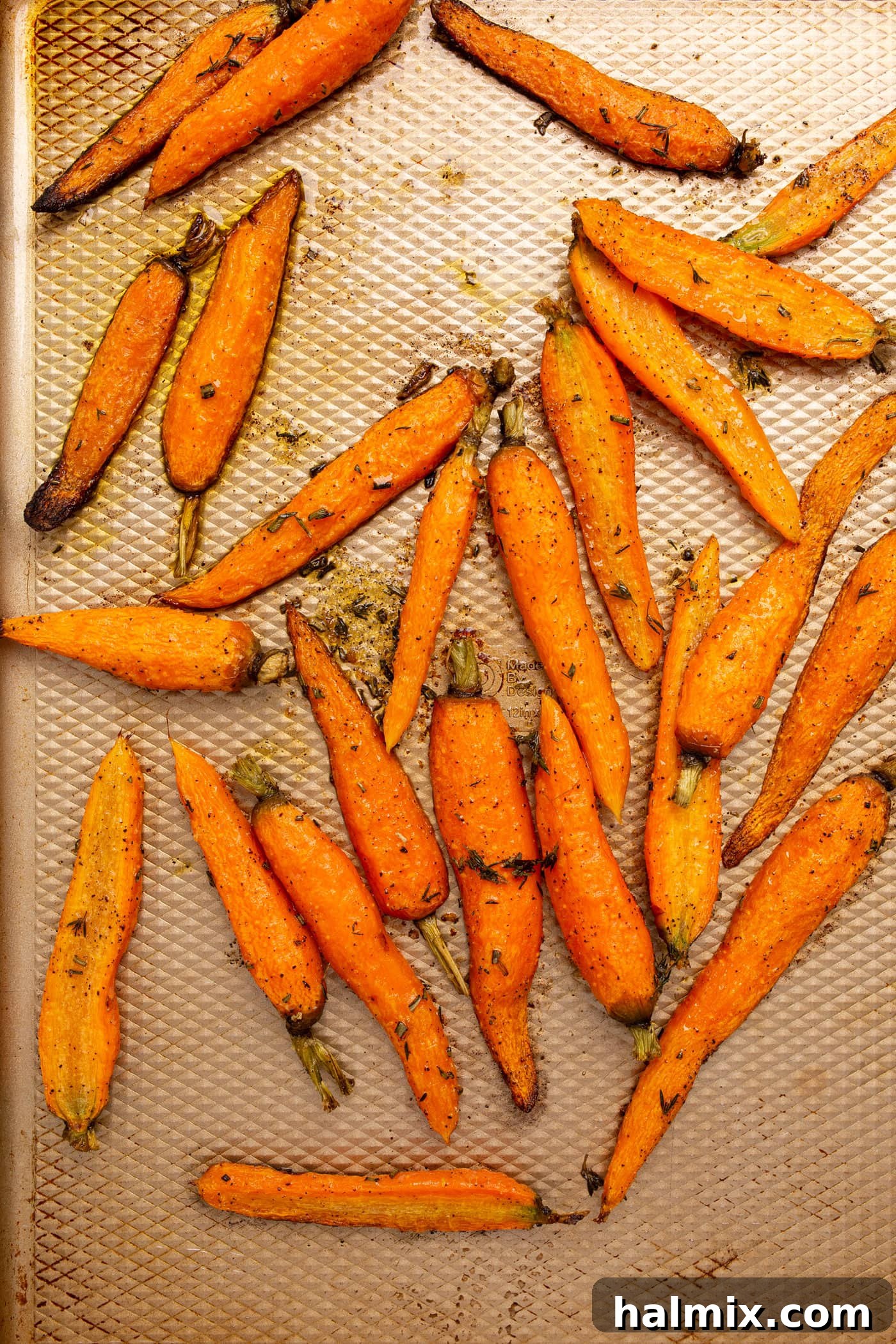 Caramelized Roasted Carrots 6 roasted carrots on a baking sheet