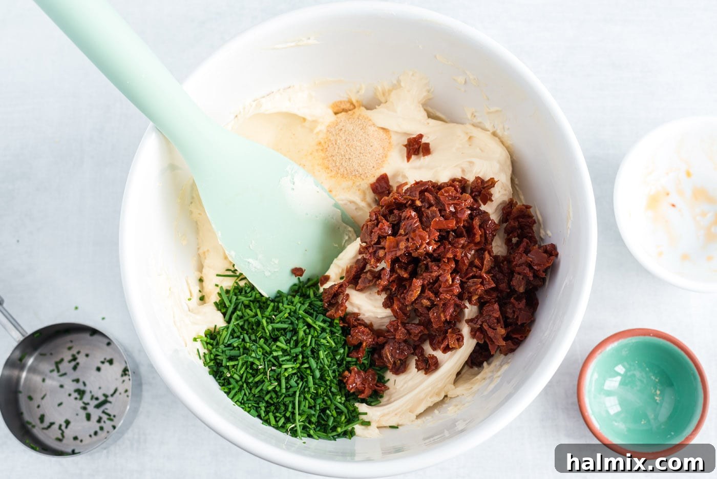 Festive Snowman Cheeseball 6 cheese mixture with sun-dried tomatoes and chives