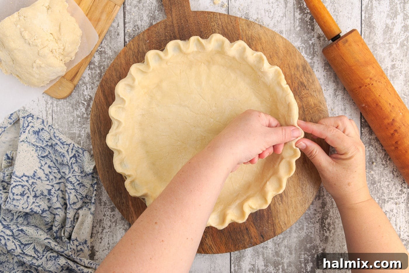 Close-up of a beautifully crimped pie dough edge in a pie plate