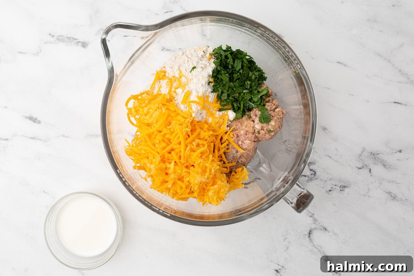 Savory Sausage Bites 5 Sausage ball ingredients being mixed together in a large mixing bowl.