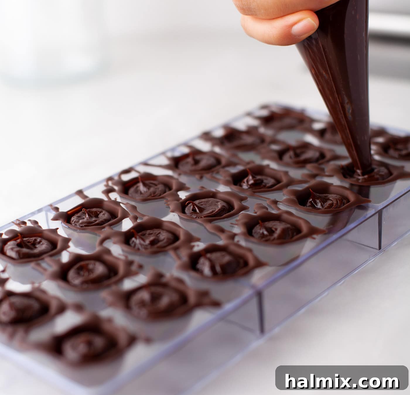 Decadent Dream Truffles 11 piping ganache into chocolate mold