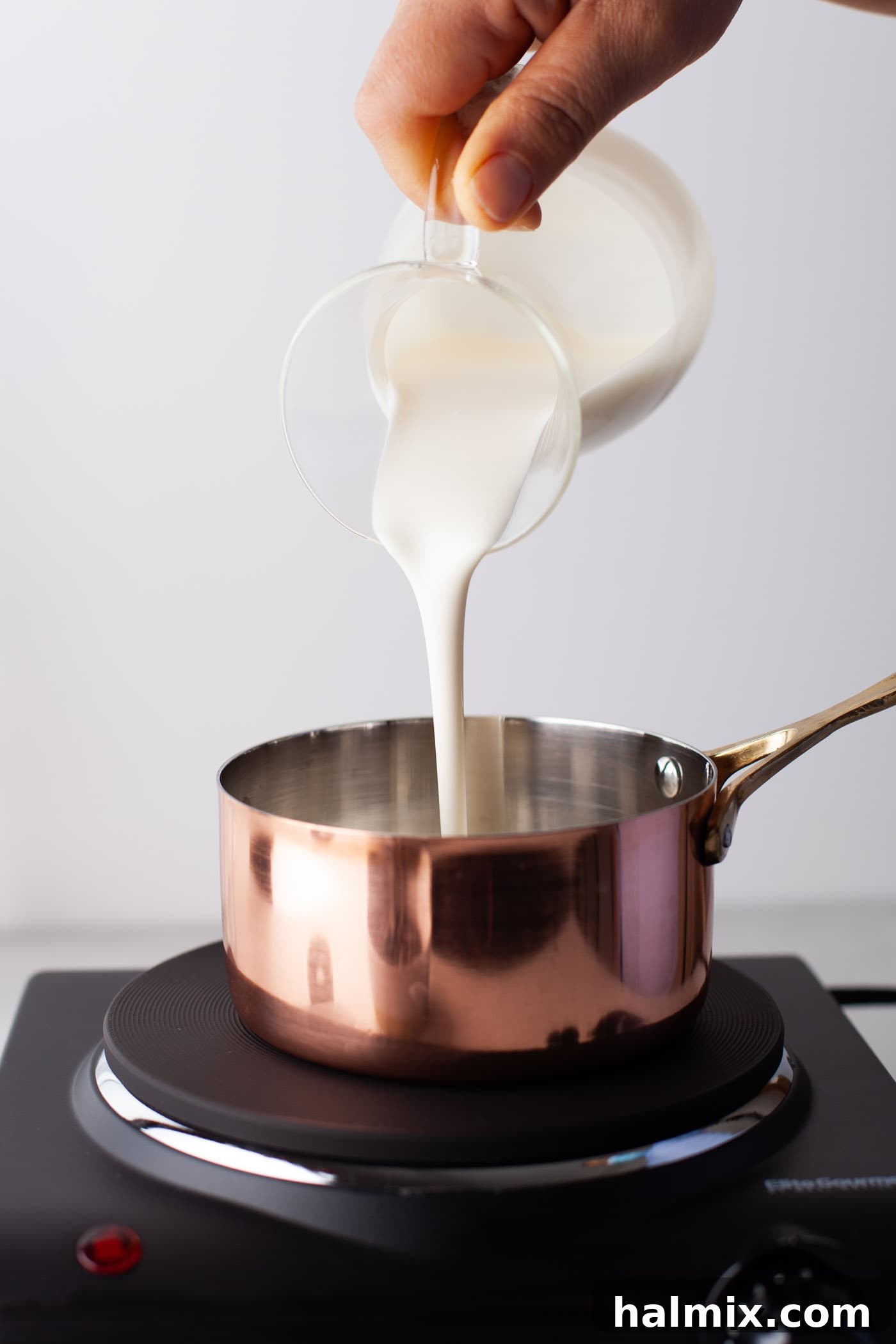 Decadent Dream Truffles 5 pouring whipping cream in a saucepan