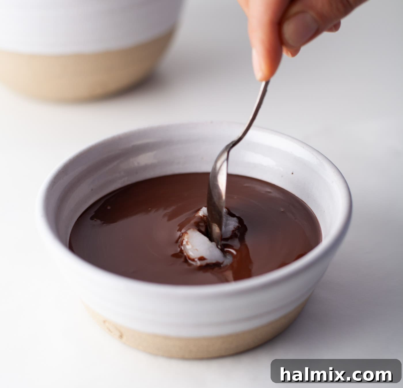 Decadent Dream Truffles 8 stirring coconut oil into melted chocolate