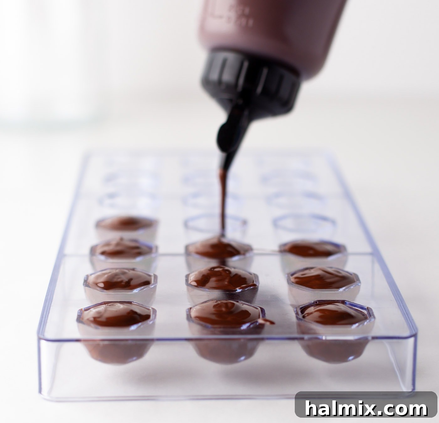 Decadent Dream Truffles 9 squeezing chocolate into candy mold