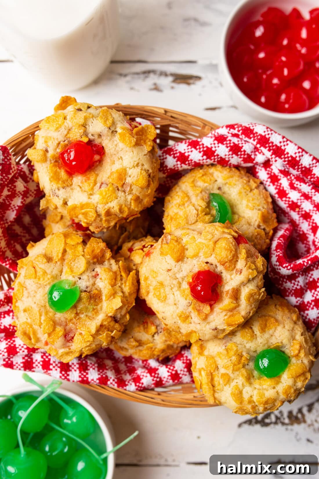 A charming basket filled with beautifully baked Cherry Wink Cookies, showcasing their vibrant cherry tops and crunchy cornflake coating, ready to be enjoyed.