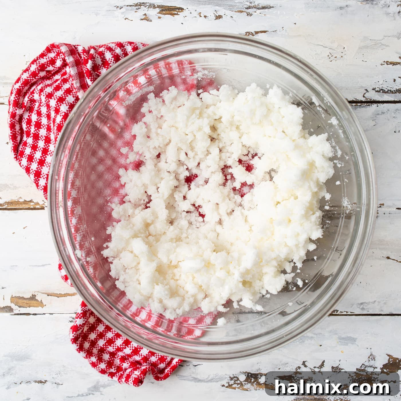 Creamed shortening and sugar mixture in a bowl, showing a light and fluffy texture, ready for the next wet ingredients.