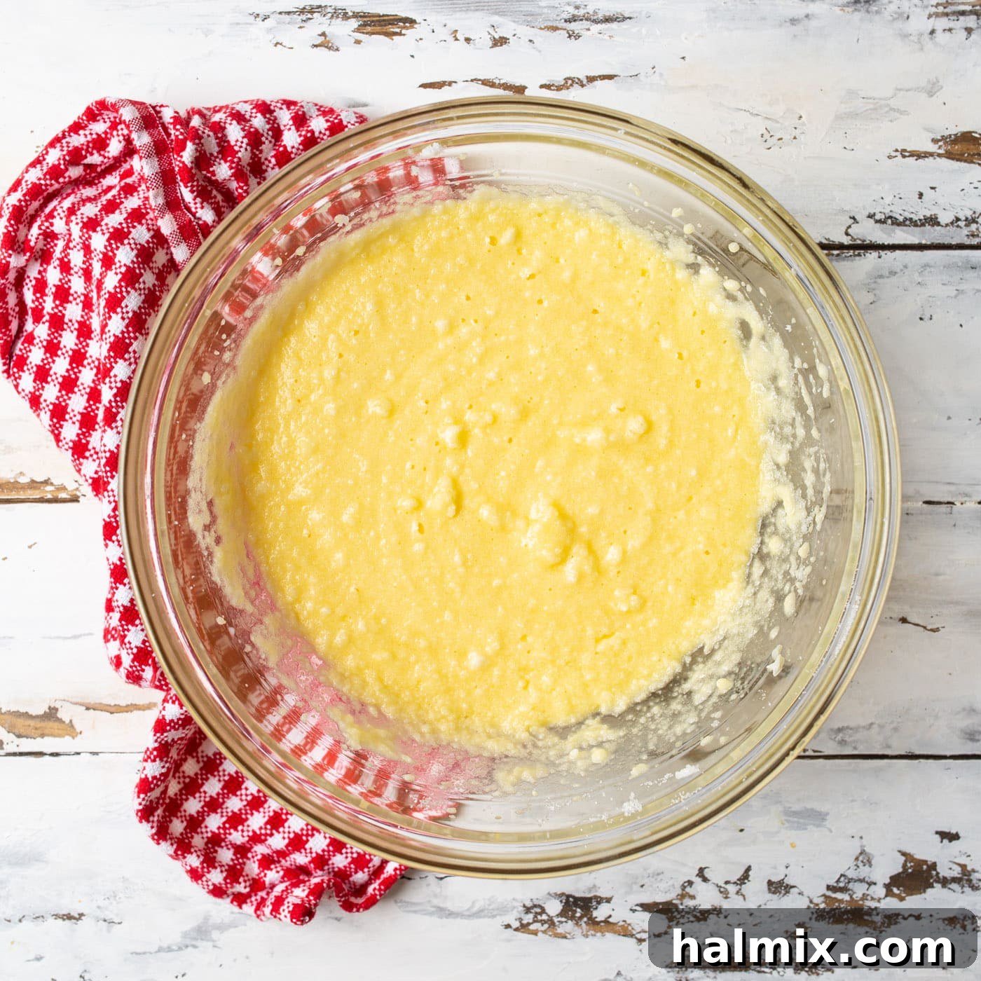 Bowl containing milk, vanilla, eggs, and the creamed shortening mixture, blended to a smooth, uniform consistency.