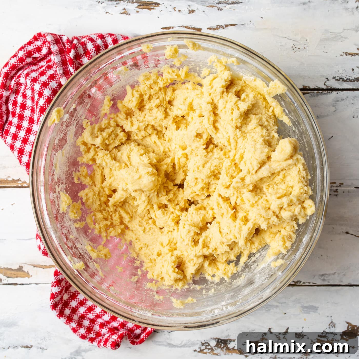 Smooth cherry wink cookie dough in a mixing bowl, showcasing its readiness for the delicious additions.