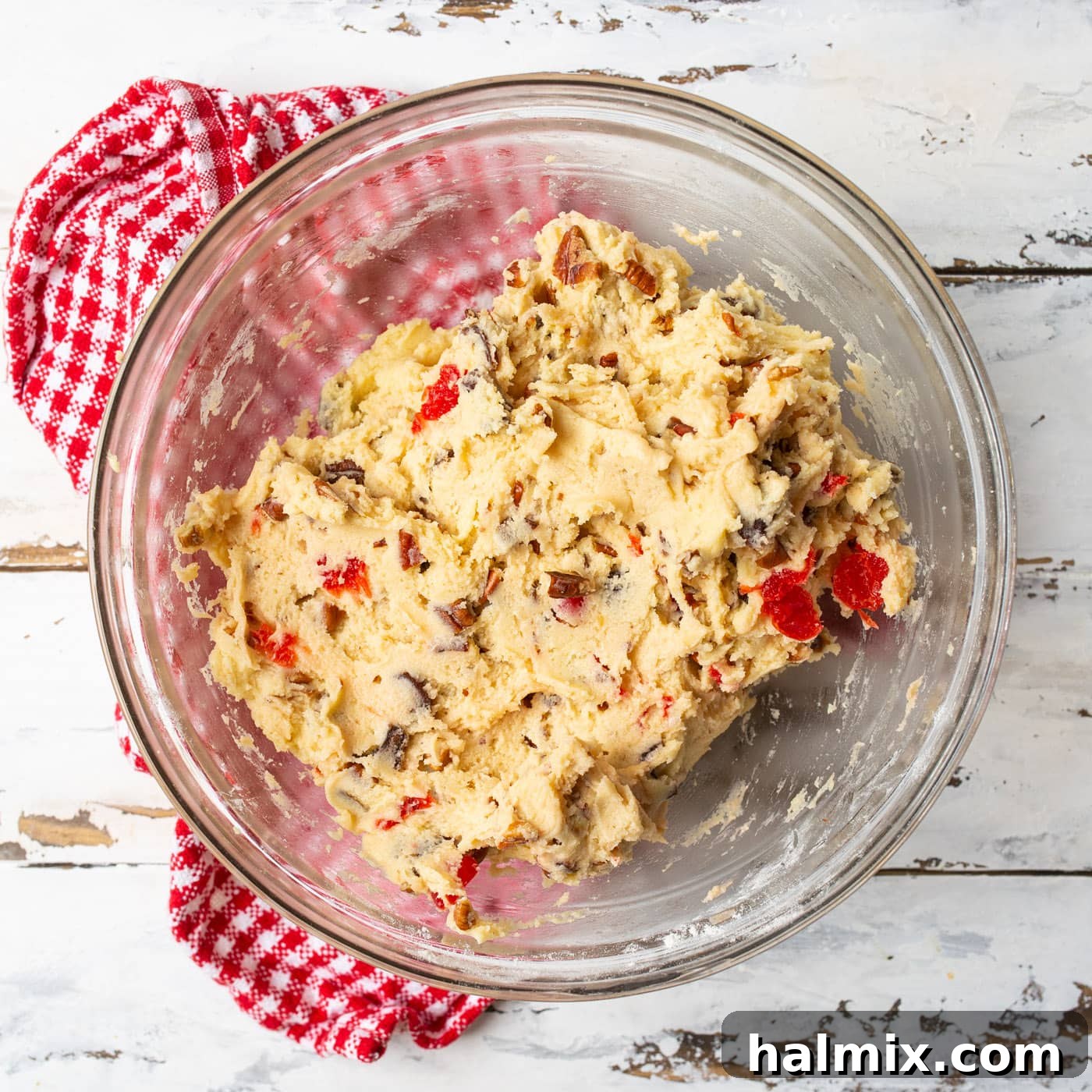 A bowl of fully mixed cherry wink cookie dough with all inclusions, ready for shaping and coating.