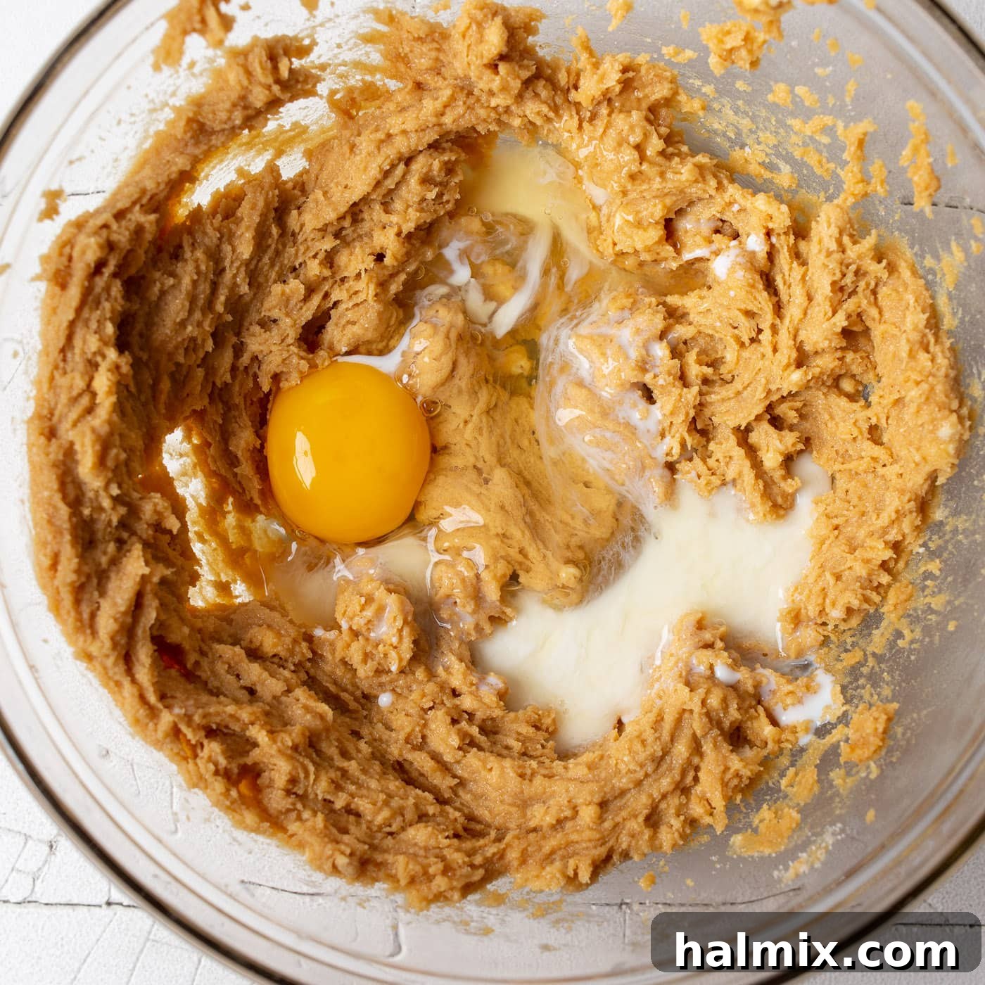 Egg, milk, and vanilla extract added to the creamy peanut butter cookie dough mixture