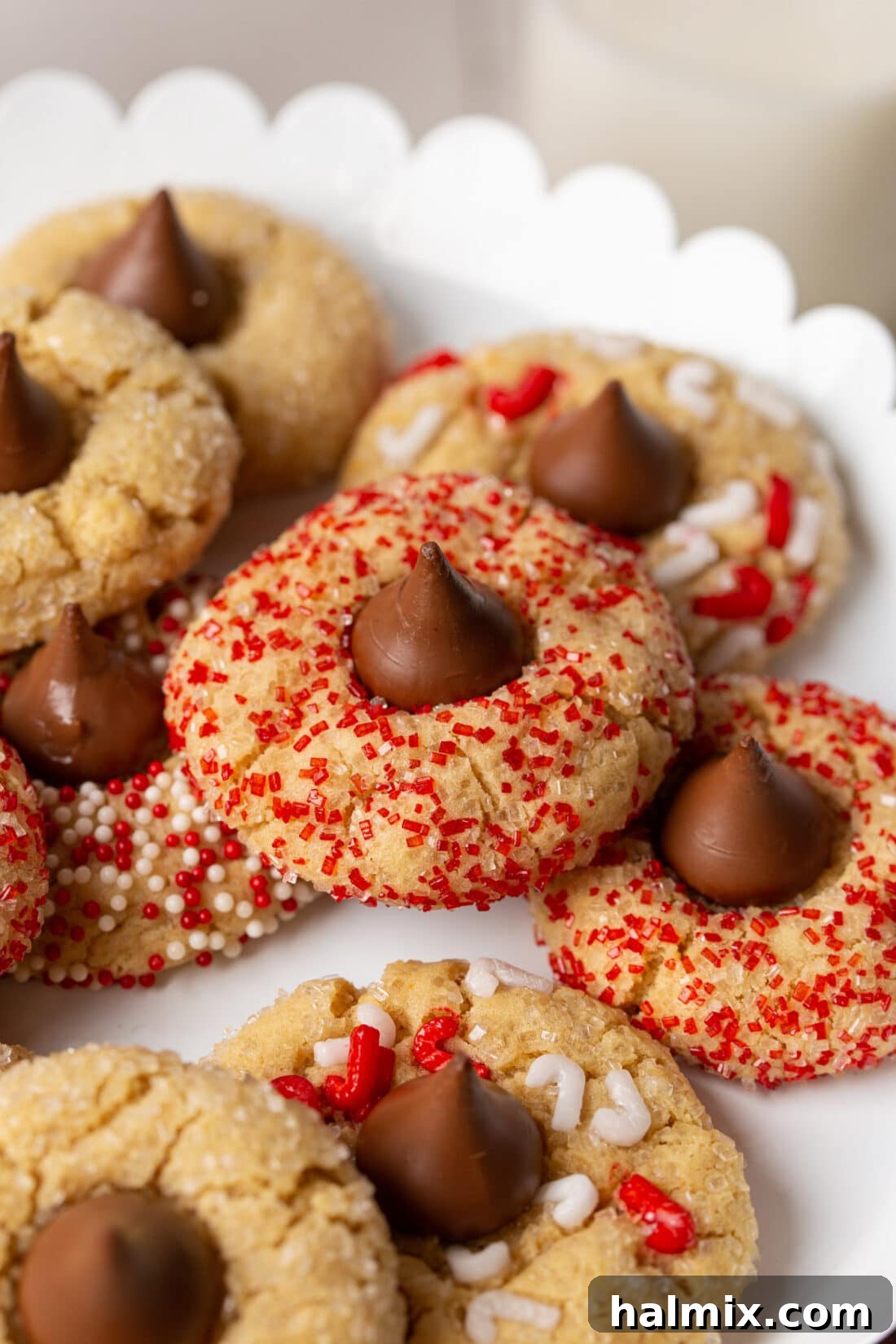 A plate stacked high with delicious Christmas Kiss Cookies ready for serving
