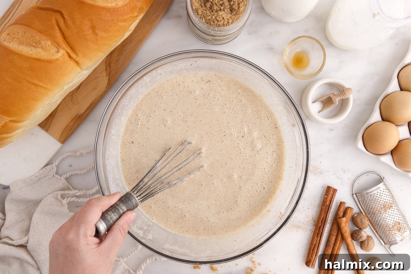 bread pudding cream mixture whisked in a bowl