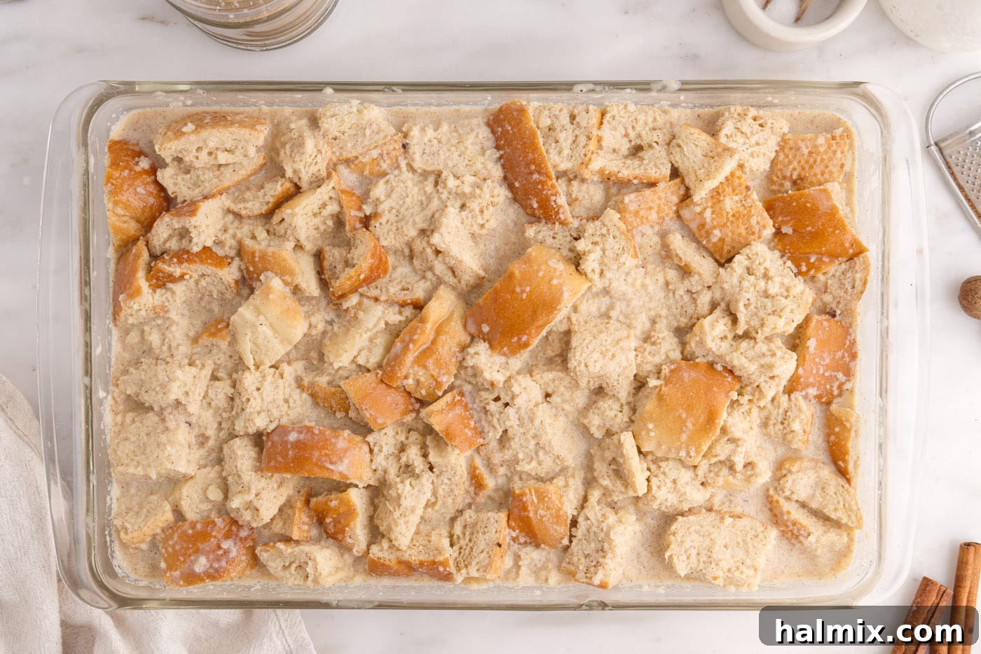 bread pudding soaking in a baking dish