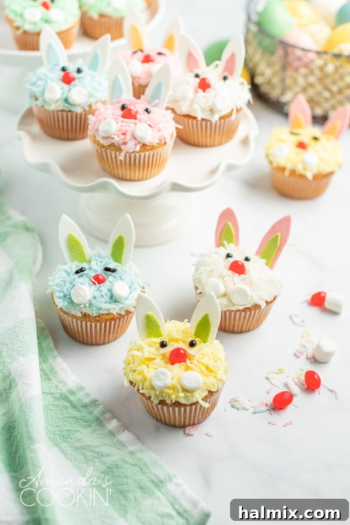 These charming Easter Bunny Cupcakes, bursting with color and playful design, are simple to create and guaranteed to be the highlight of your holiday celebrations. A delightful collection of finished Easter bunny cupcakes, showcasing their vibrant variety of colored coconut, cute gum ears, jelly bean noses, and expressive eyes, ready to be served.