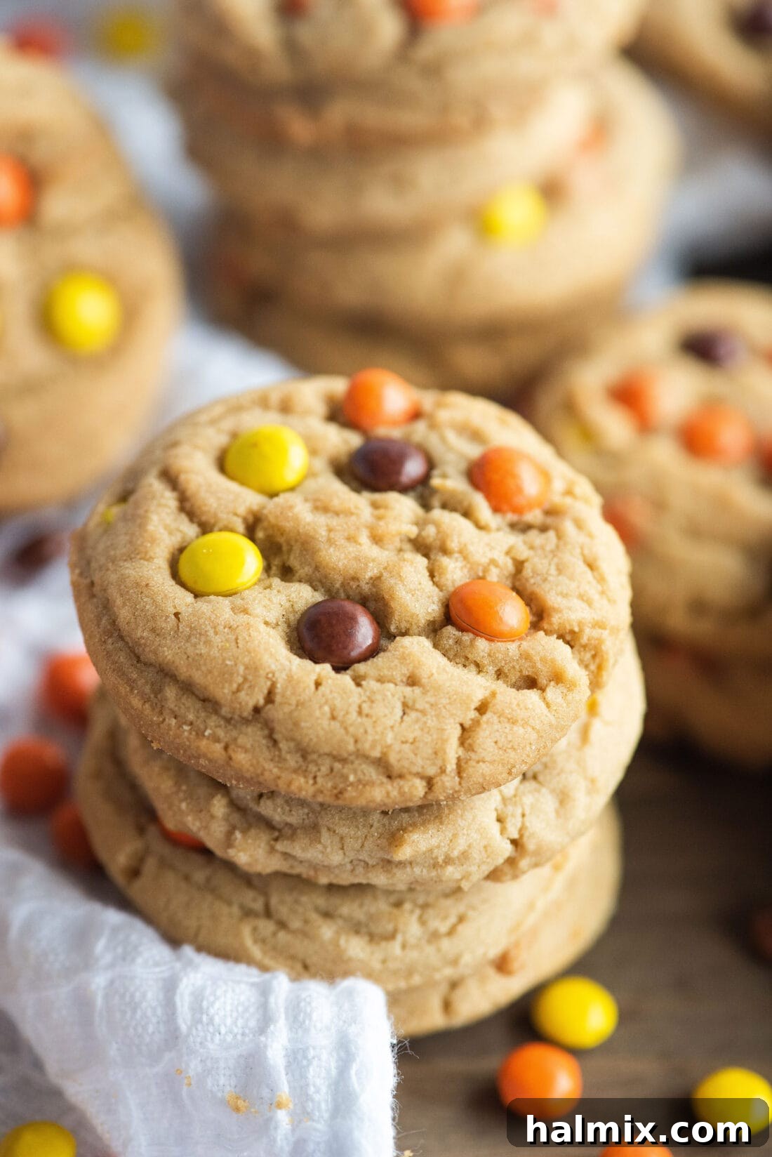 Stacked Reese's Pieces Cookies with one showing a bite taken out