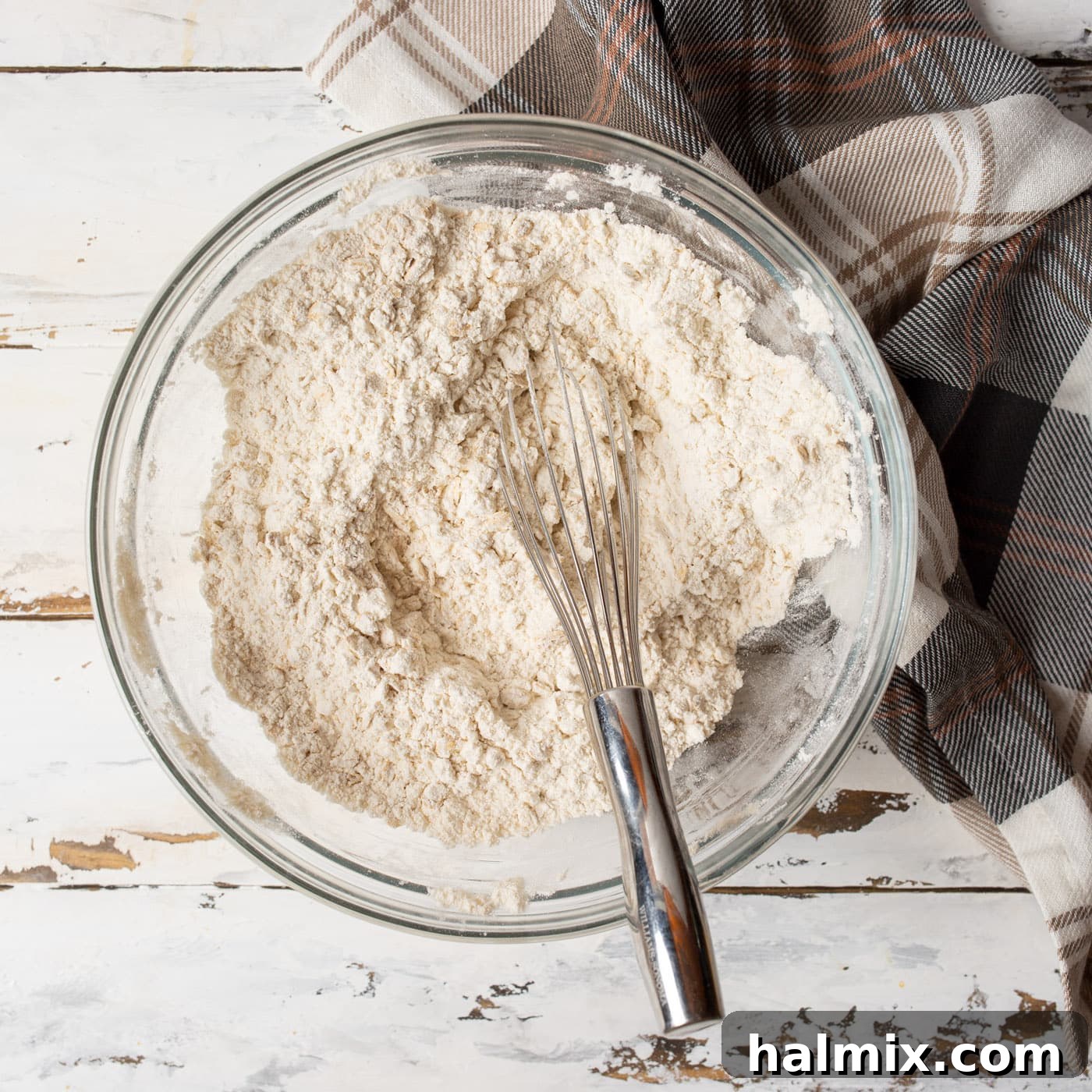 Spiced Oatmeal Raisin Delights 5 dry ingredients for cookies in a mixing bowl with a whisk