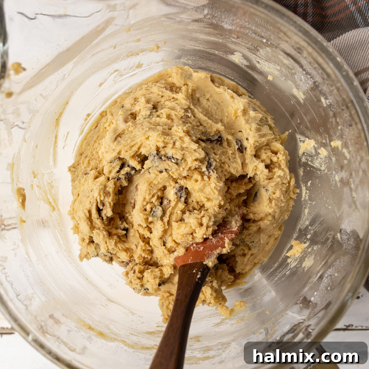 Spiced Oatmeal Raisin Delights 7 wooden spoon stirring oatmeal raisin cookie dough