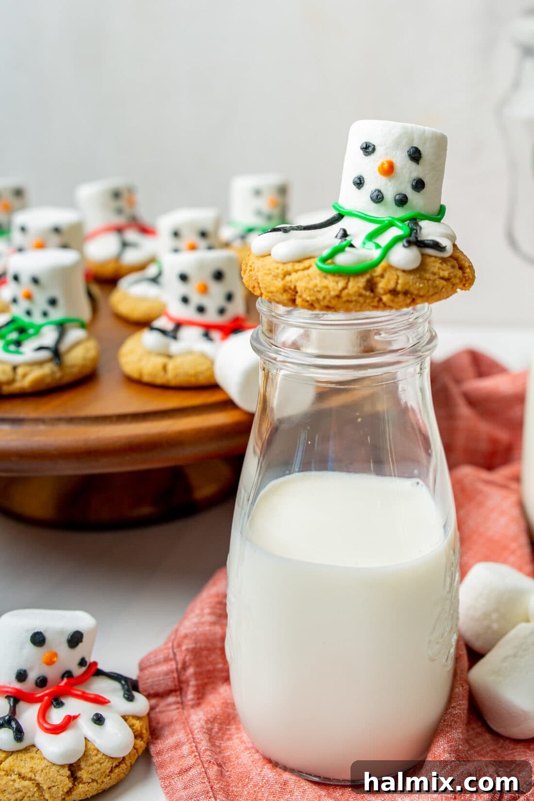 A melted snowman cookie casually leaning against a bottle of milk, ready for a sweet treat.