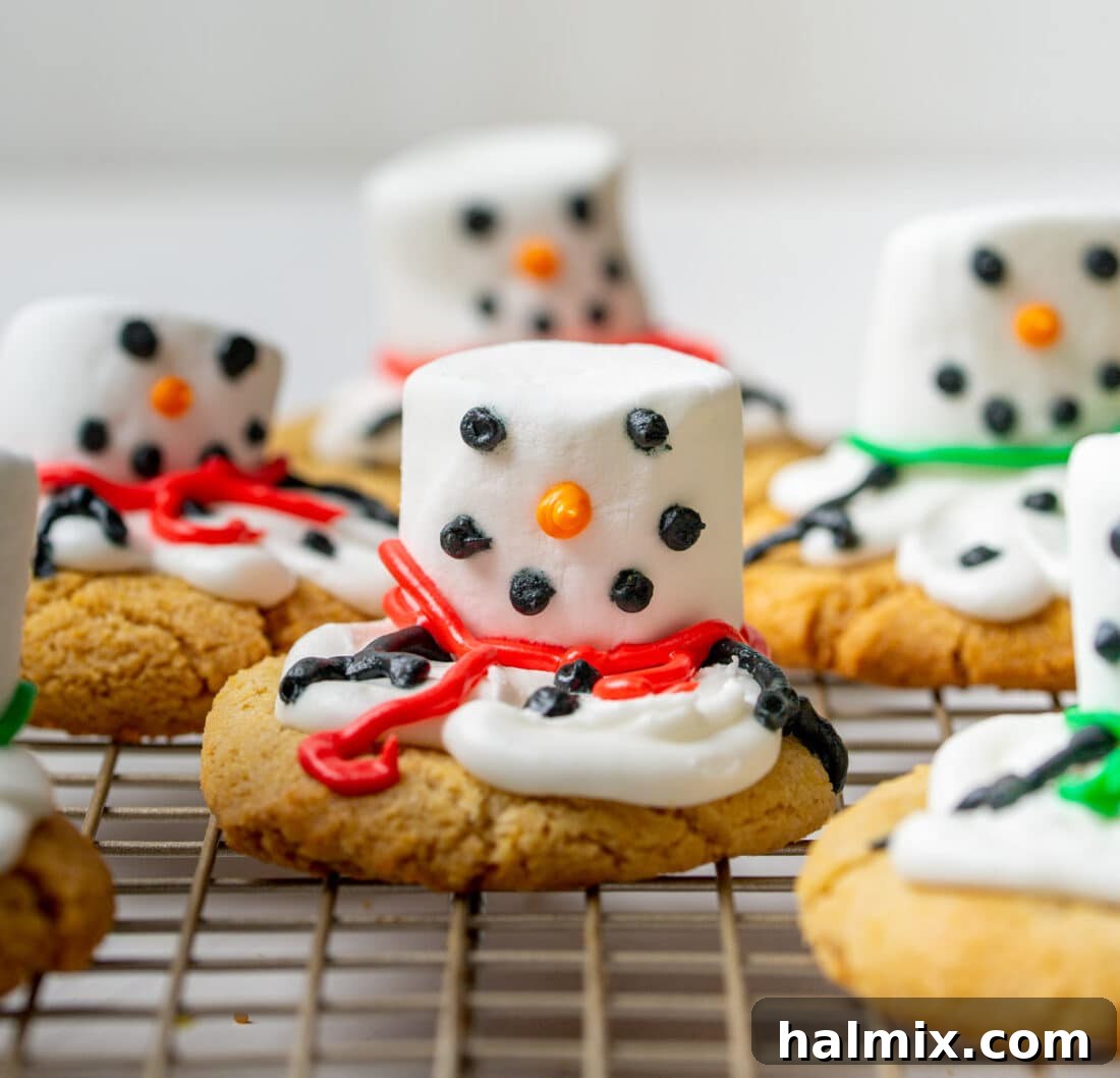 Freshly decorated melted snowman cookies cooling on a wire rack.