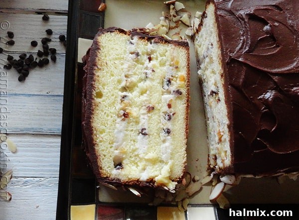 A perfectly portioned slice of Cassata Cake, revealing its luscious layers of cake and creamy filling.