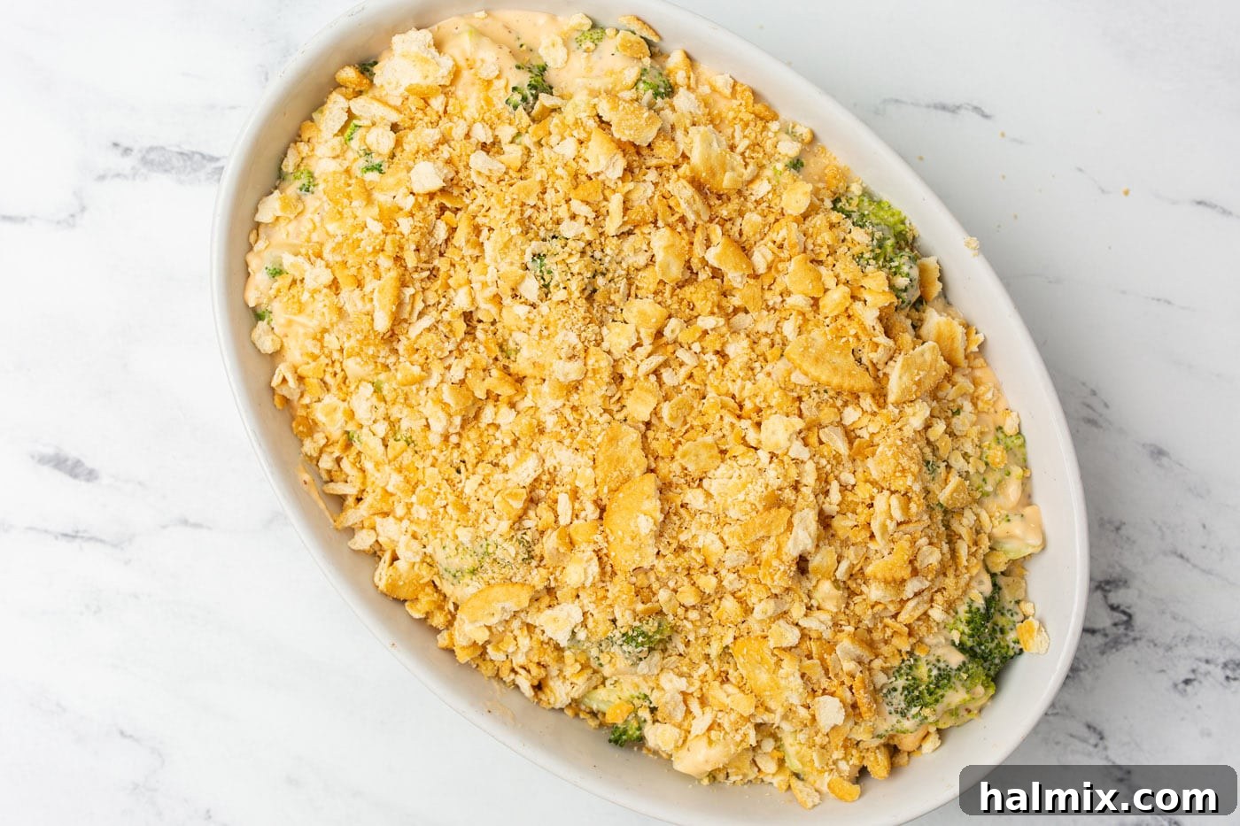 Broccoli casserole garnished with a crispy Ritz cracker topping.