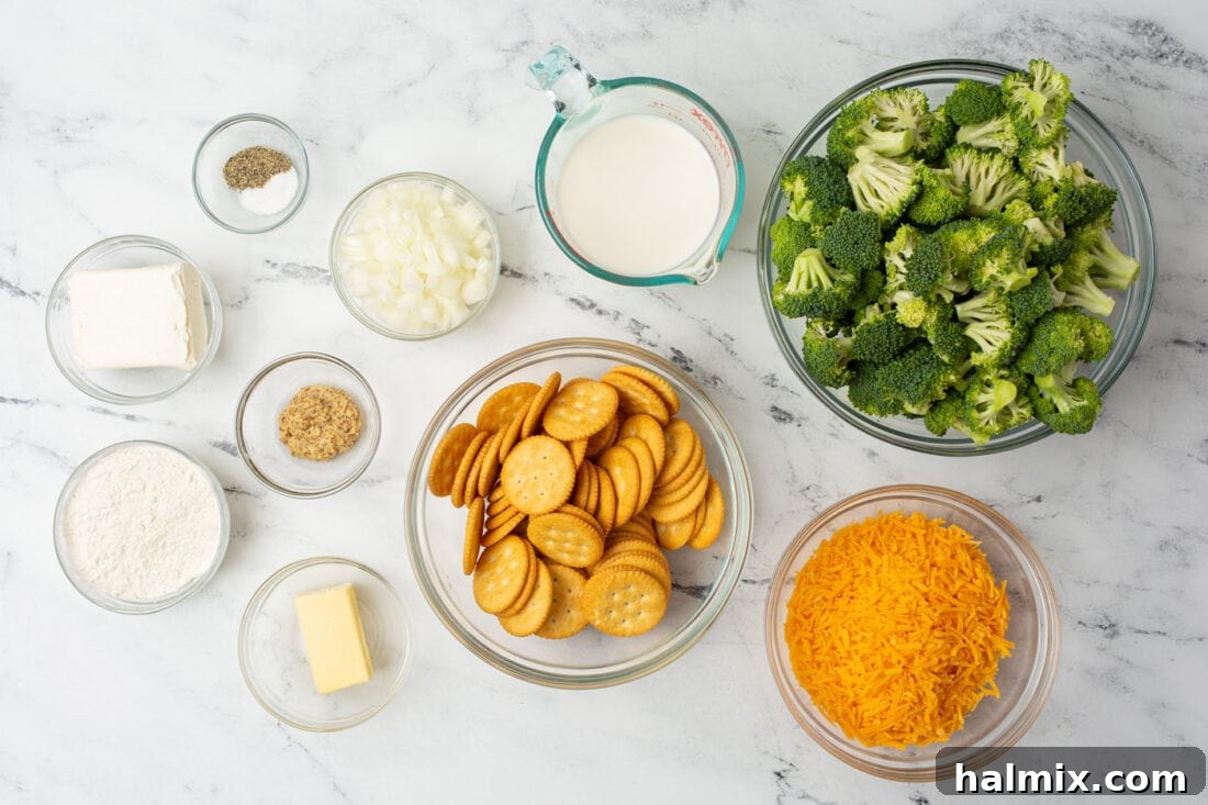 A selection of fresh ingredients laid out, including broccoli, cheese, crackers, milk, and other items for making broccoli casserole.