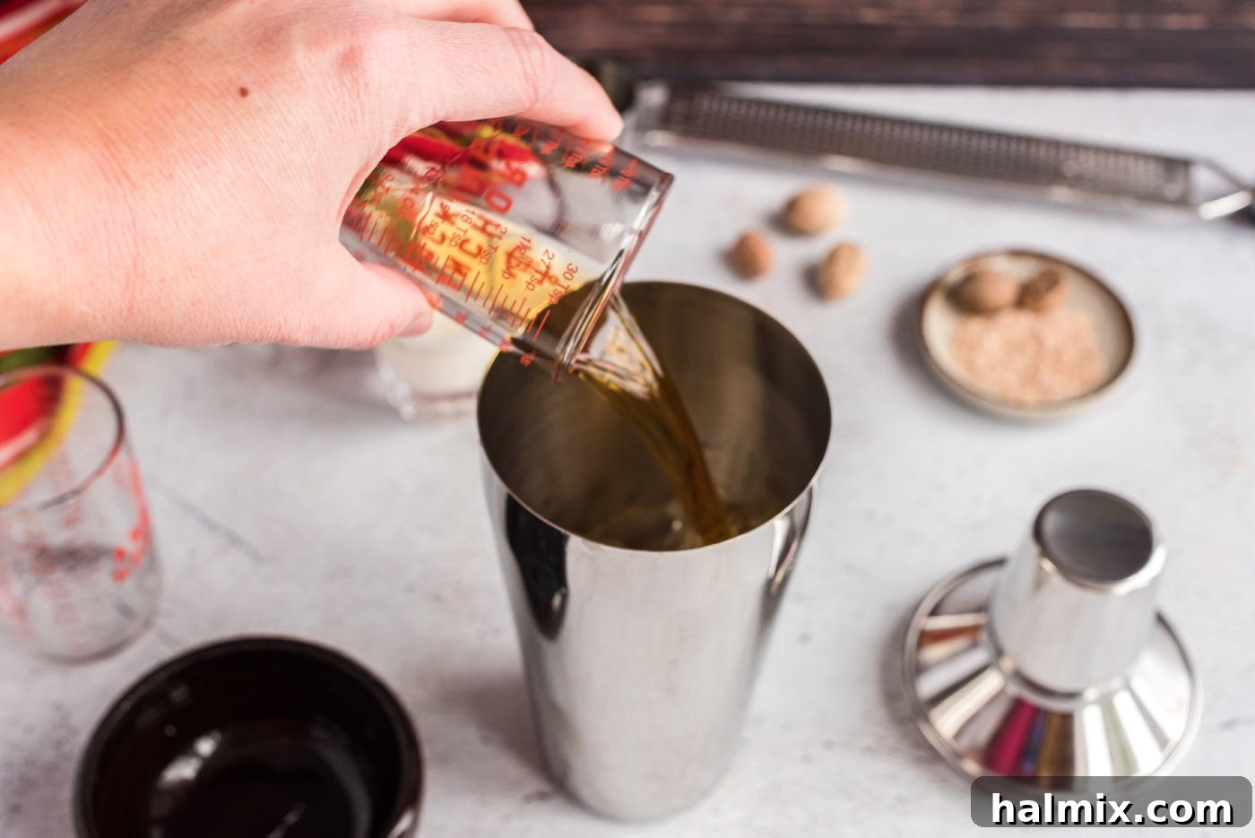 Velvet Brandy Dream 6 pouring brandy into cocktail shaker