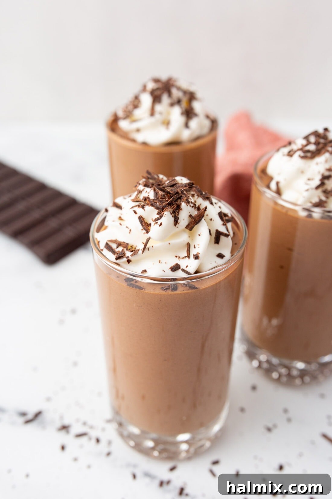 Silken Chocolate Indulgence 2 Exquisitely light and rich homemade chocolate mousse topped with fluffy whipped cream and a sprinkle of chocolate shavings in an elegant serving glass.