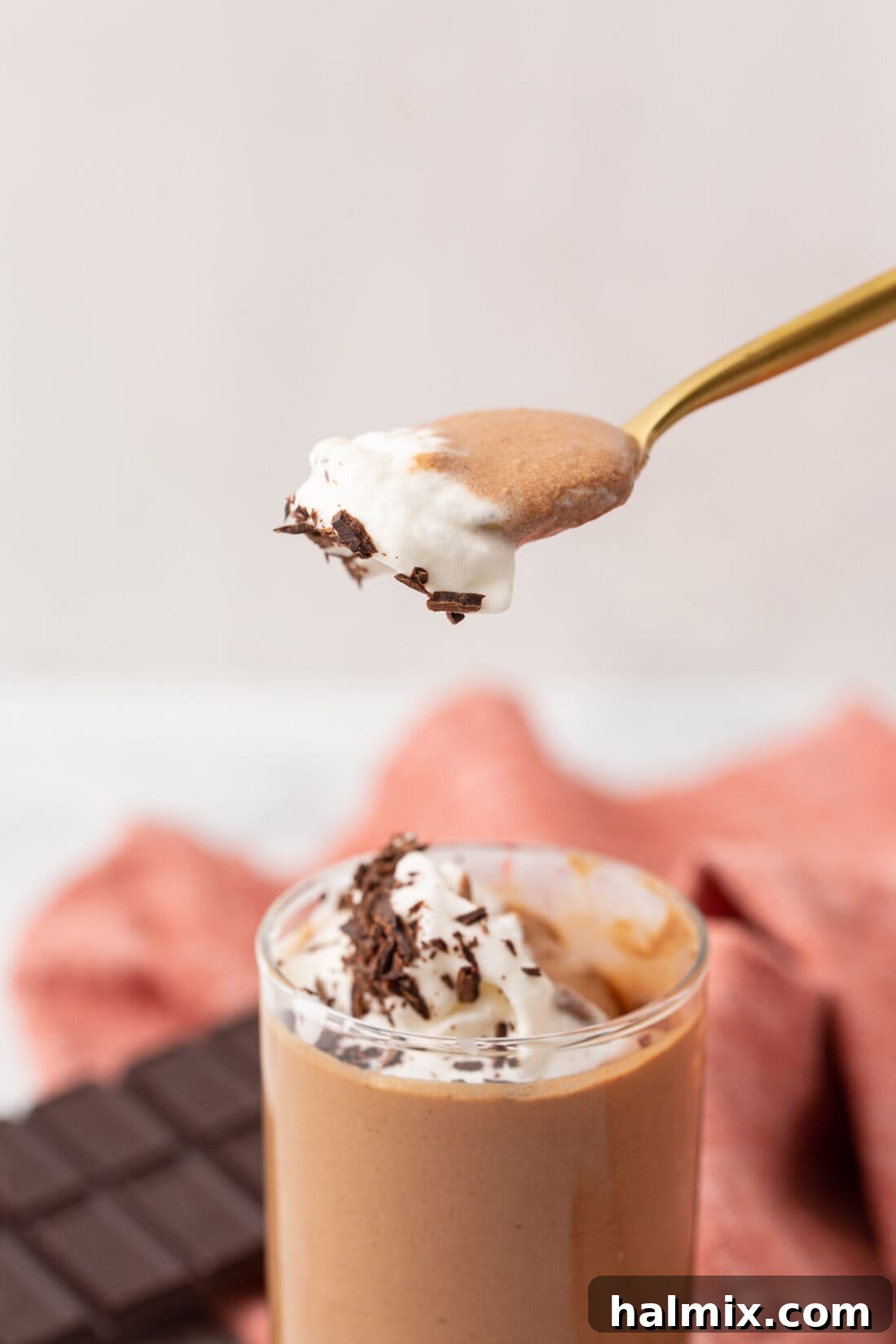 Silken Chocolate Indulgence 3 A spoon expertly scooping into a homemade chocolate mousse, highlighting its smooth and luxurious texture.