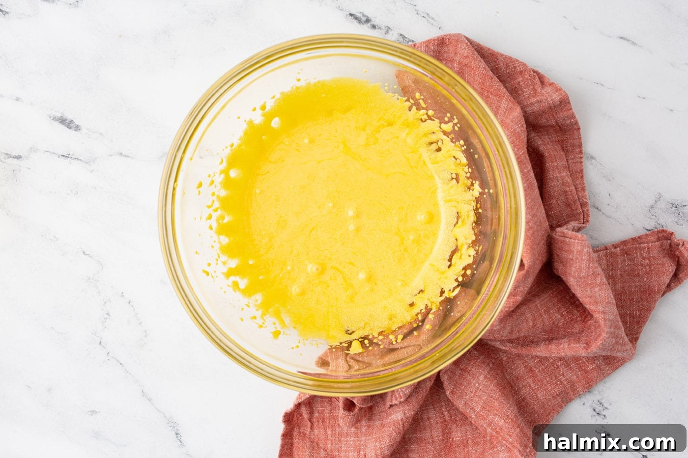 Silken Chocolate Indulgence 5 Whipped egg yolks and sugar in a mixing bowl, showing a pale yellow, fluffy texture.