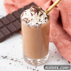 Silken Chocolate Indulgence 10 A beautifully set chocolate mousse in an elegant glass serving dish, garnished with whipped cream.