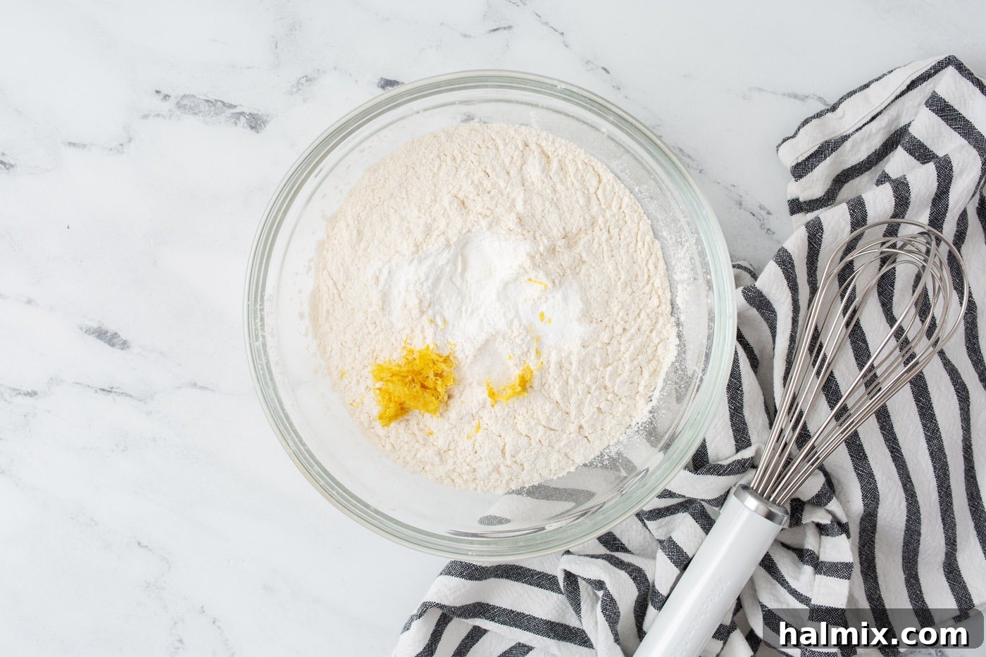 Bowl with flour, baking powder, baking soda, and salt, ready to be whisked.