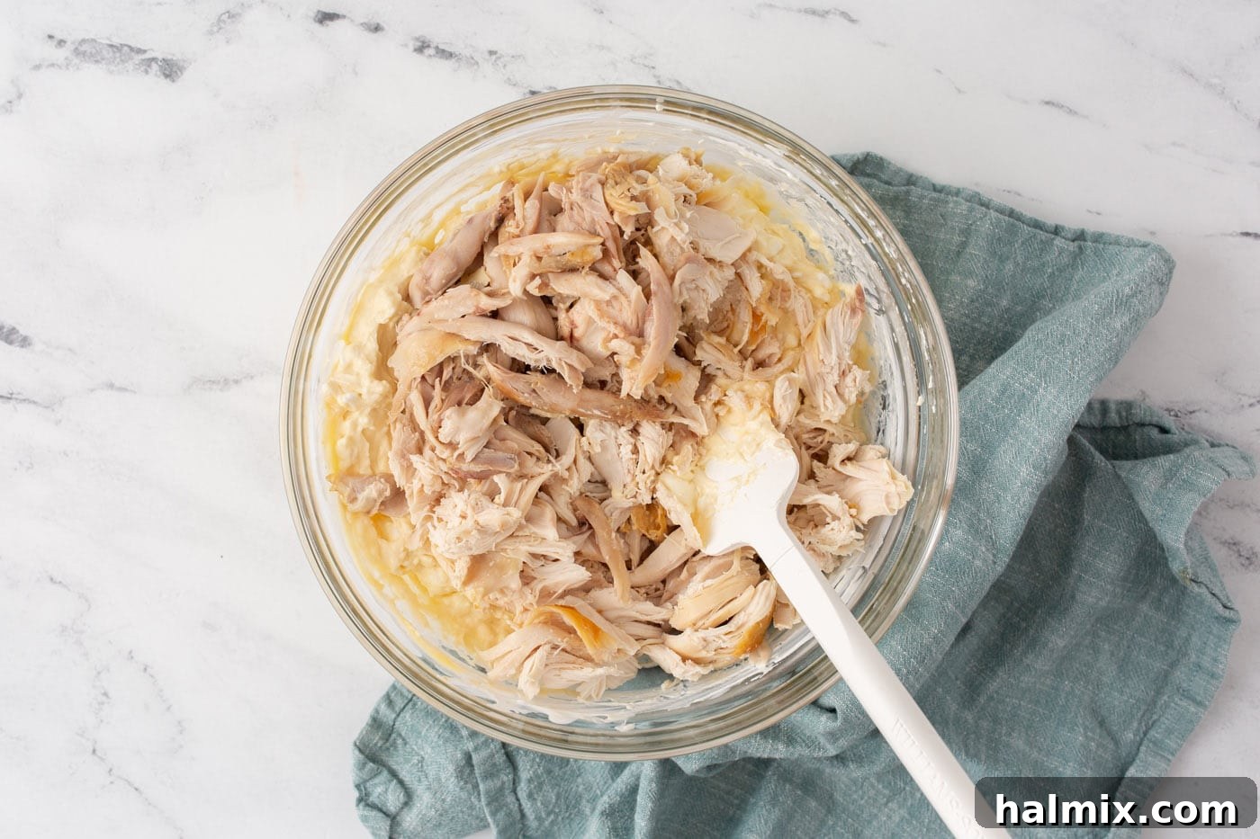 Stirring chicken into cream cheese mixture for casserole