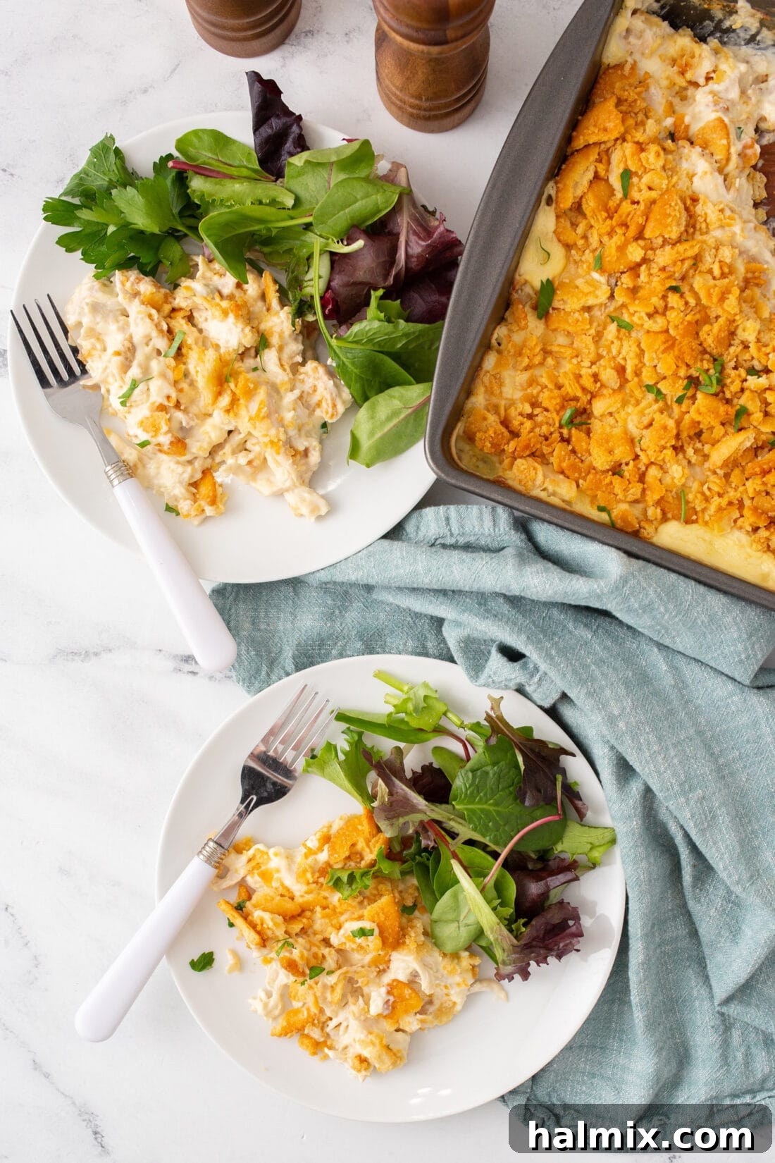 Plates of Million Dollar Chicken Casserole served with a side