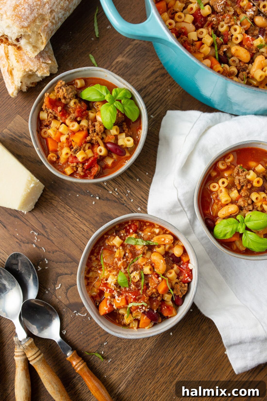 Two cozy bowls of Pasta Fagioli soup, steaming hot and garnished, ready to be enjoyed.