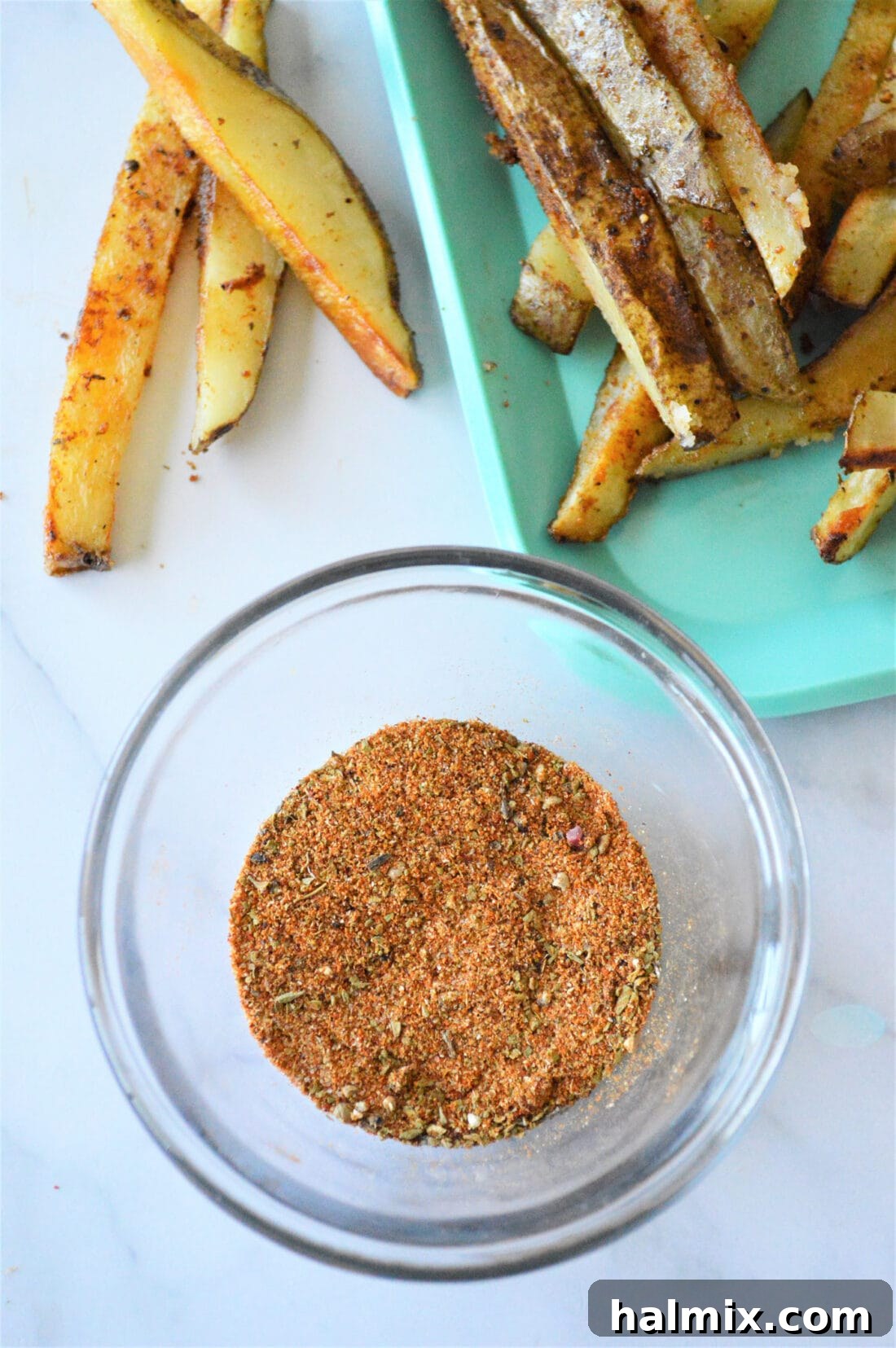 A bowl filled with a homemade spice blend, showcasing the vibrant colors of garlic salt, cumin, oregano, chili powder, and paprika.