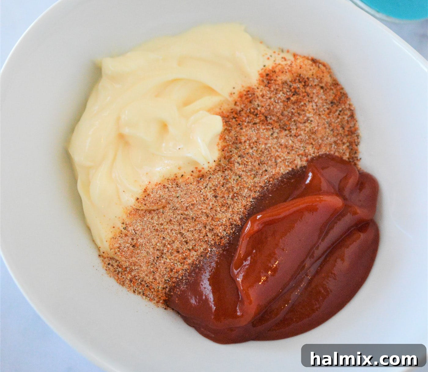 All the French fry sauce ingredients being whisked together in a bowl for a smooth blend