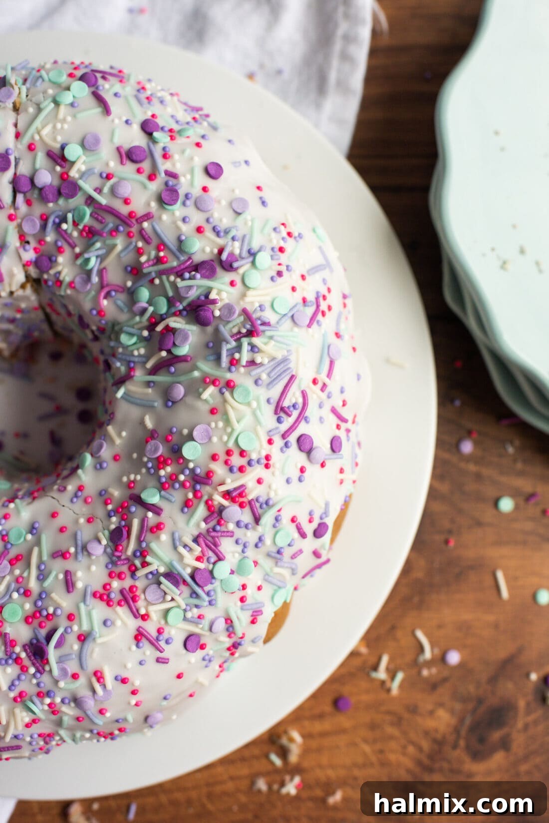 Overhead view of a vibrant Unicorn Bundt Cake with pastel swirls and colorful sprinkles, perfectly glazed.