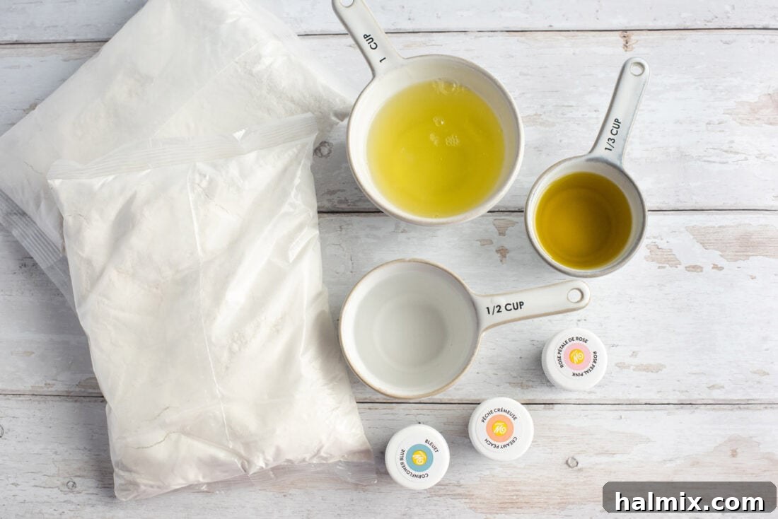 Assortment of dry and wet ingredients laid out on a clean surface for baking a Unicorn Bundt Cake, including cake mix, eggs, oil, milk, and food coloring.