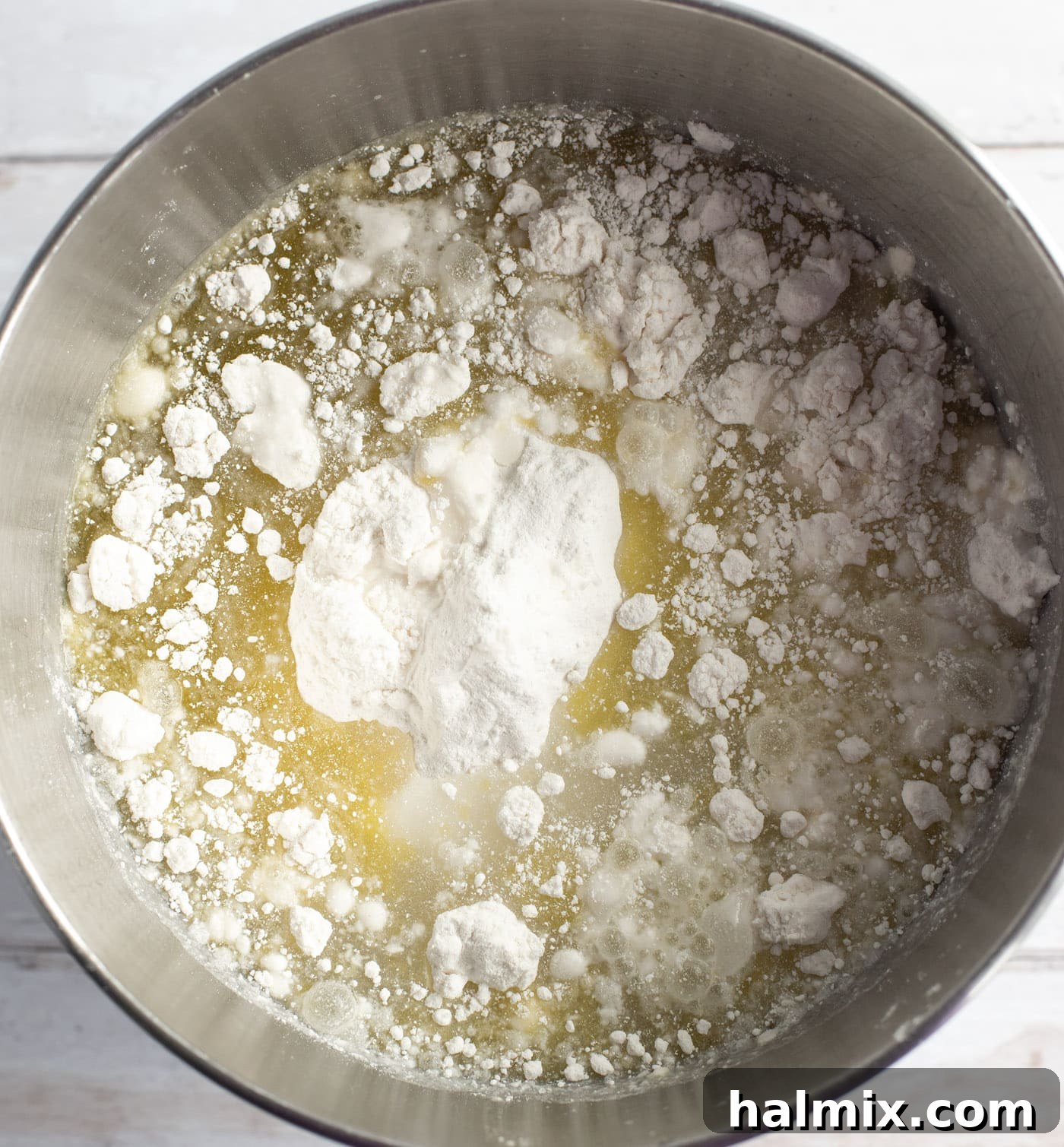 Cake mix, oil, and eggs in a large mixing bowl, ready to be combined into a smooth batter.