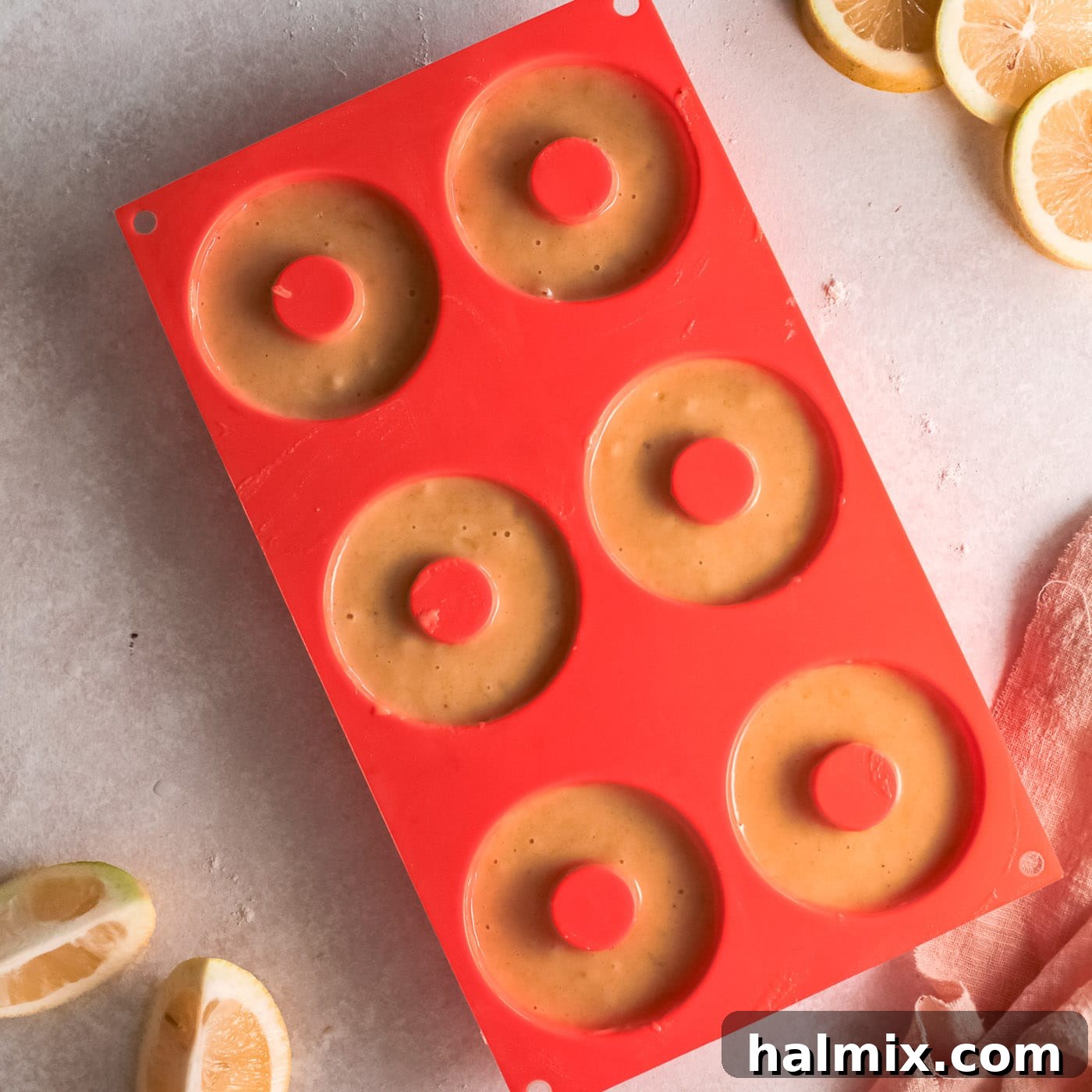 Zesty Baked Lemon Donuts 8 donuts baking in a silicone donut pan