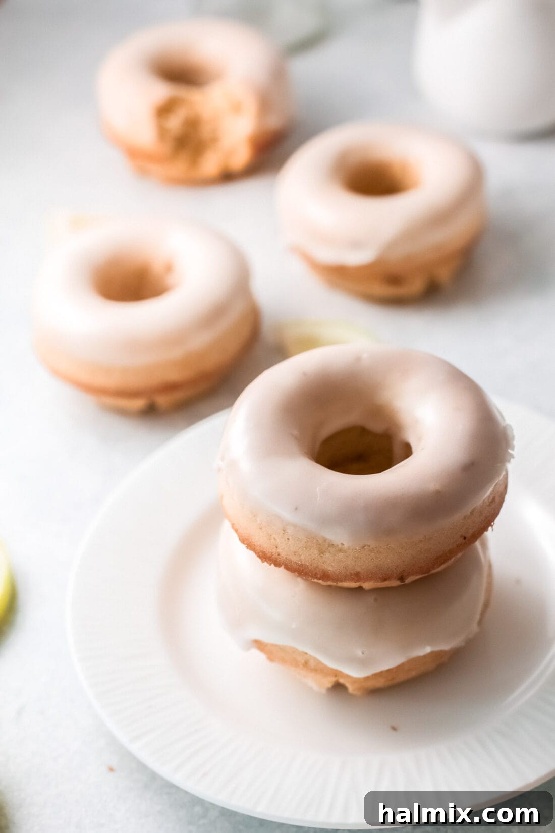 Zesty Baked Lemon Donuts 10 A stack of freshly made Lemon Baked Donuts with a sweet glaze